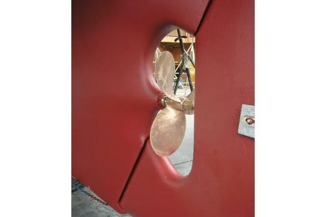 Avenir Yacht Photos Pics Propeller of 1982 Ta Shing Mason 63 yacht, viewed through red hull opening.