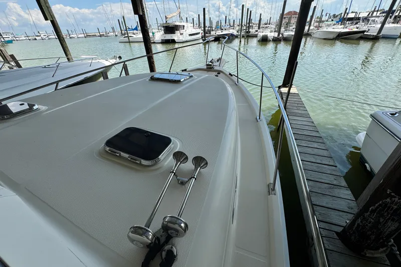  Yacht Photos Pics 2003 Mainship Pilot 34 docked at marina, showcasing deck and surrounding boats.