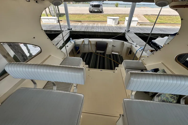  Yacht Photos Pics 2003 Mainship Pilot 34 boat interior with seating and dock view.
