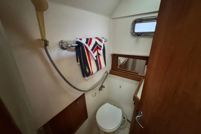 Yacht Photos Pics 2003 Mainship Pilot 34 bathroom with shower, toilet, and colorful towels.