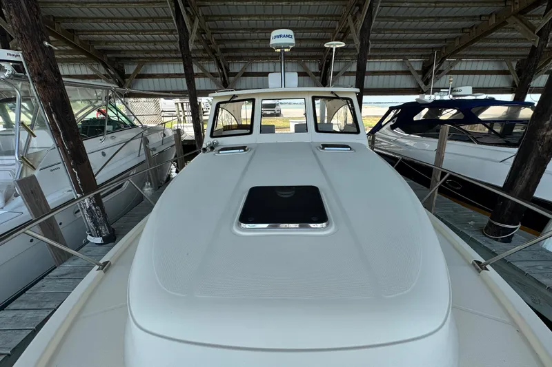  Yacht Photos Pics 2003 Mainship Pilot 34 boat docked under a covered marina.