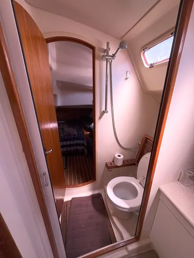 Bylgja Yacht Photos Pics 2005 Hunter 38 yacht bathroom with shower, toilet, and wooden accents.