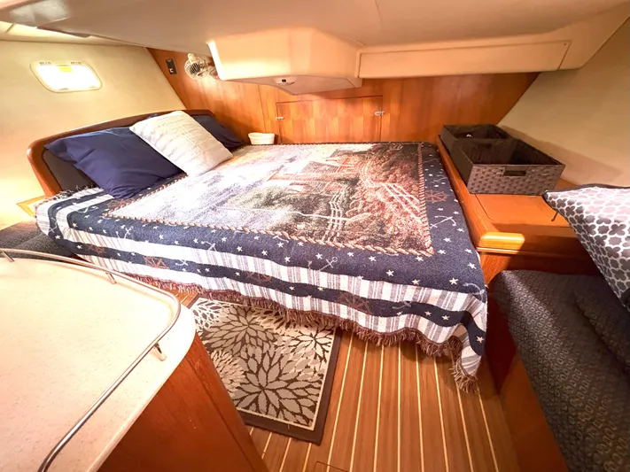 Bylgja Yacht Photos Pics Cozy cabin interior of 2005 Hunter 38 sailboat with bed and wooden accents.