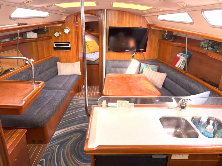 Bylgja Yacht Photos Pics Interior of a 2005 Hunter 38 sailboat with cozy seating and modern amenities.