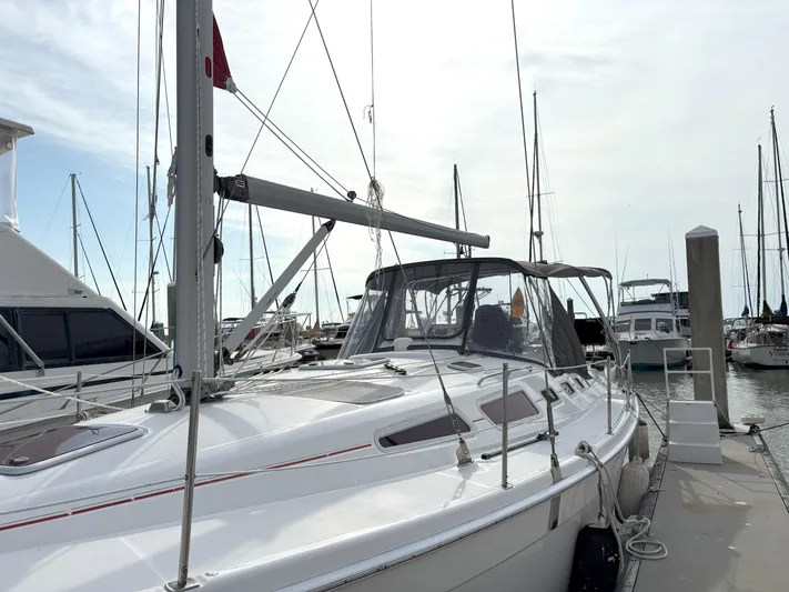 Bylgja Yacht Photos Pics 2005 Hunter 38 sailboat docked at marina, surrounded by other boats.