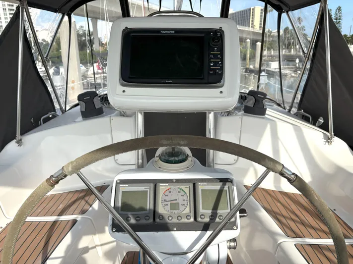 Bylgja Yacht Photos Pics 2005 Hunter 38 sailboat cockpit with navigation equipment and steering wheel.