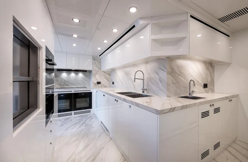 Numarine 40mxp Yacht Photos Pics Modern kitchen in 2026 Numarine 40MXP yacht with sleek white cabinetry and marble countertops.
