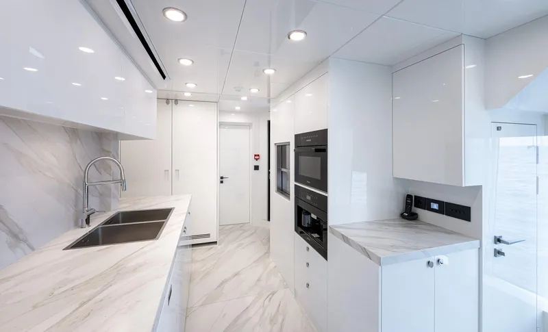 Numarine 40mxp Yacht Photos Pics Modern kitchen interior on 2026 Numarine 40MXP yacht, featuring sleek white cabinetry and marble countertops.