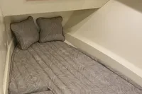 2024 Chris-Craft Launch 35GT cabin interior with bed and TV.
