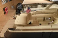2024 Chris-Craft Launch 35GT boat with American flag in a wooden dock setting.