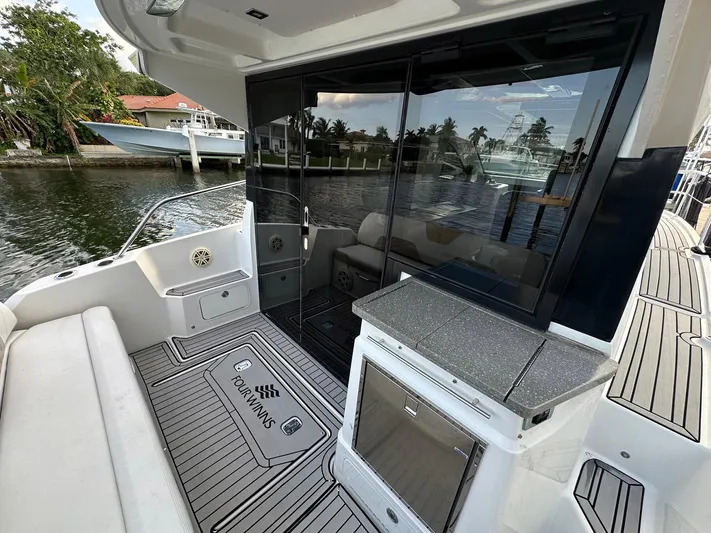 Olivia Yacht Photos Pics 2020 Four Winns Vista 355 Coupe boat deck with seating and waterfront view.