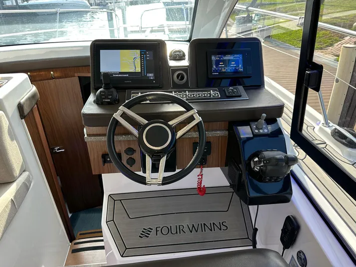 Olivia Yacht Photos Pics 2020 Four Winns Vista 355 Coupe helm with modern navigation displays and controls.