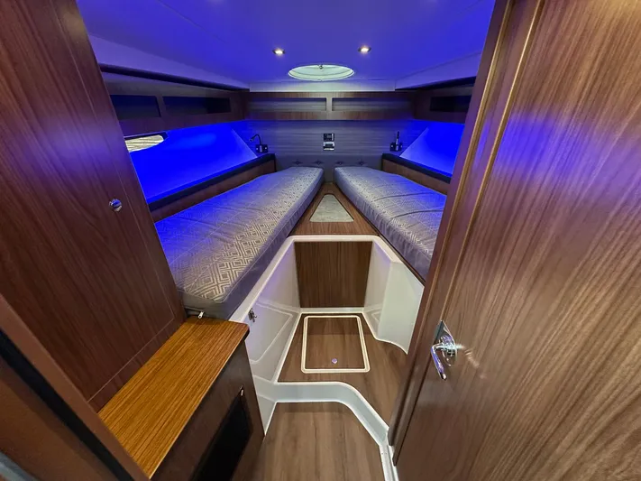 Olivia Yacht Photos Pics 2020 Four Winns Vista 355 Coupe interior with blue lighting and wooden finishes.