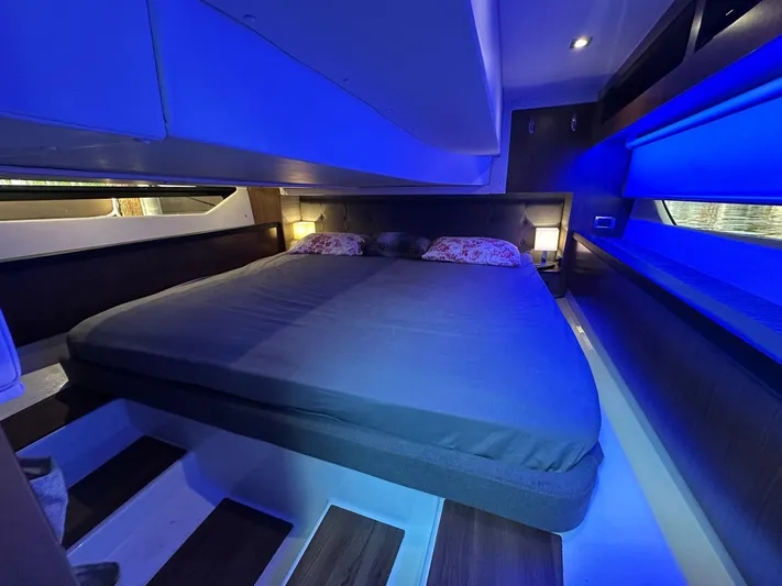 Olivia Yacht Photos Pics Luxurious cabin interior of 2020 Four Winns Vista 355 Coupe with ambient blue lighting.