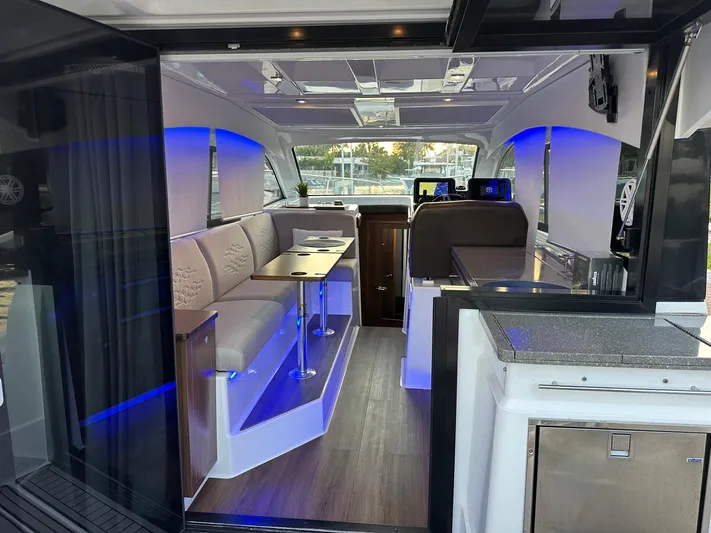Olivia Yacht Photos Pics 2020 Four Winns Vista 355 Coupe interior with modern seating and ambient lighting.
