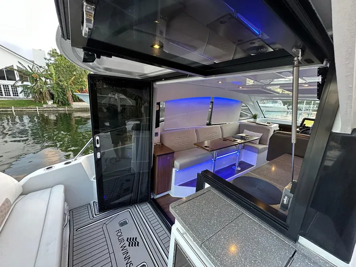 Olivia Yacht Photos Pics Interior view of 2020 Four Winns Vista 355 Coupe yacht with modern seating and ambient lighting.