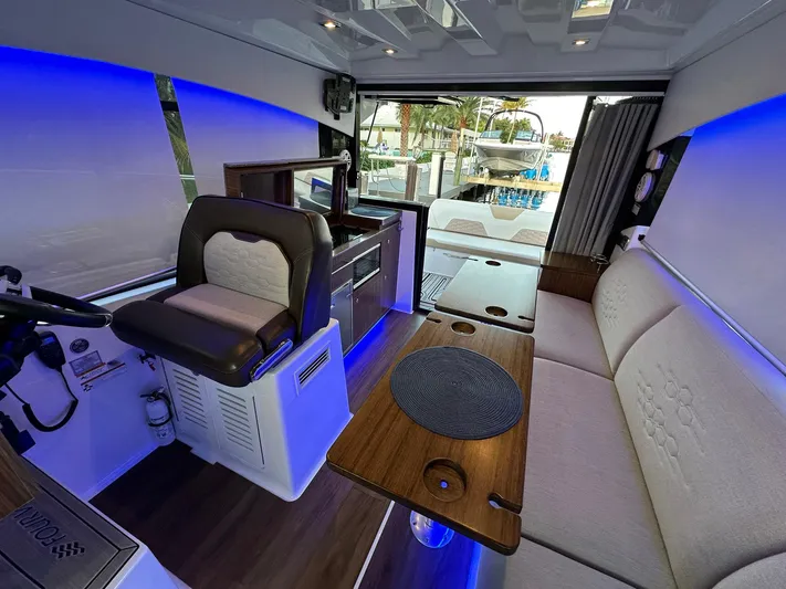 Olivia Yacht Photos Pics Interior of 2020 Four Winns Vista 355 Coupe with modern seating and ambient lighting.