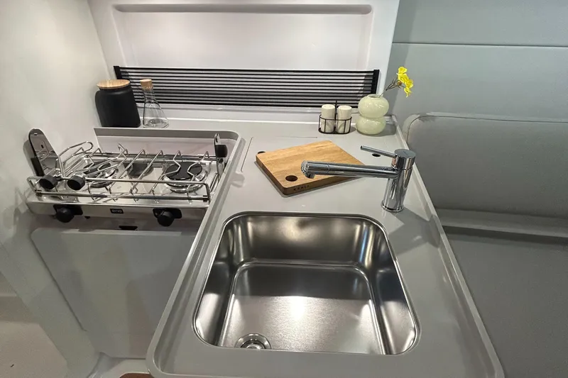  Yacht Photos Pics Modern galley kitchen in 2025 Beneteau First 30 yacht with sink and stove.