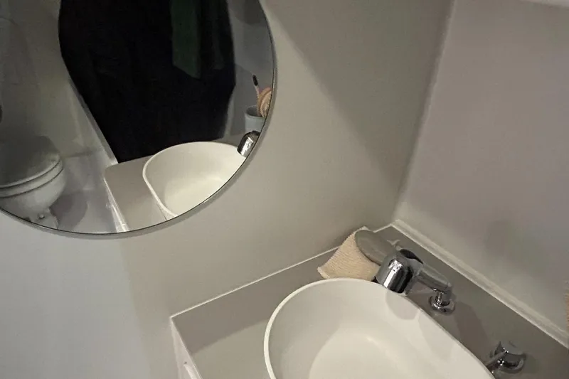  Yacht Photos Pics Bathroom interior of 2025 Beneteau First 30 yacht with modern sink and mirror.