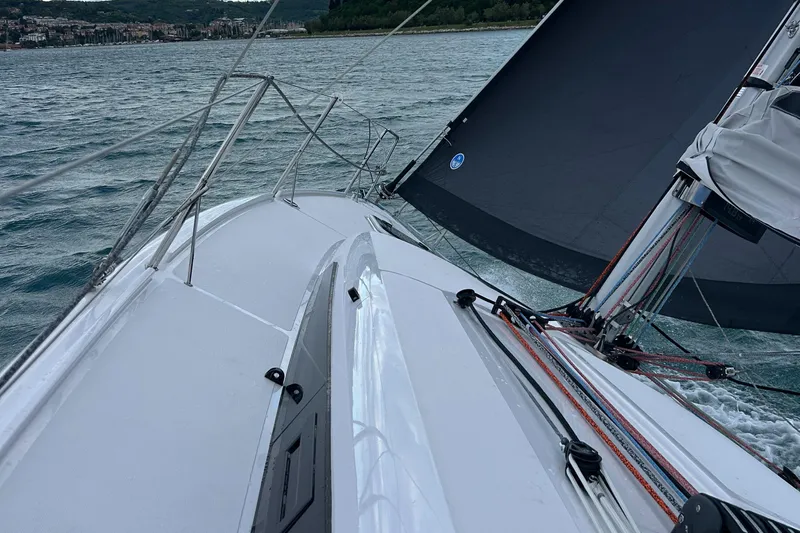  Yacht Photos Pics 2025 Beneteau First 30 sailboat navigating on a lake with visible sails and deck.