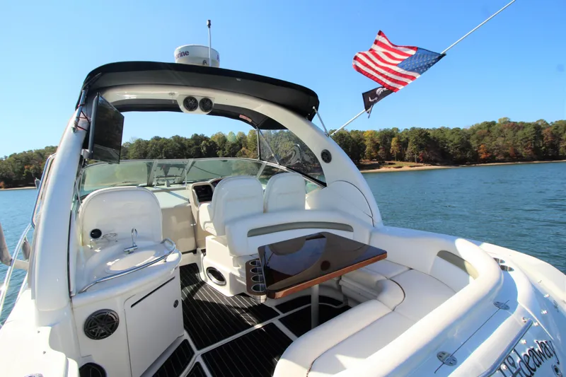  Yacht Photos Pics 2006 Sea Ray 340 Sundancer yacht interior with American flag, on a serene lake.