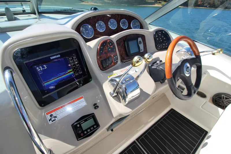  Yacht Photos Pics 2006 Sea Ray 340 Sundancer helm with navigation screens, gauges, and wood-accented steering wheel.