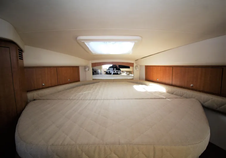  Yacht Photos Pics Interior cabin of 2006 Sea Ray 340 Sundancer with bed and wooden storage cabinets.