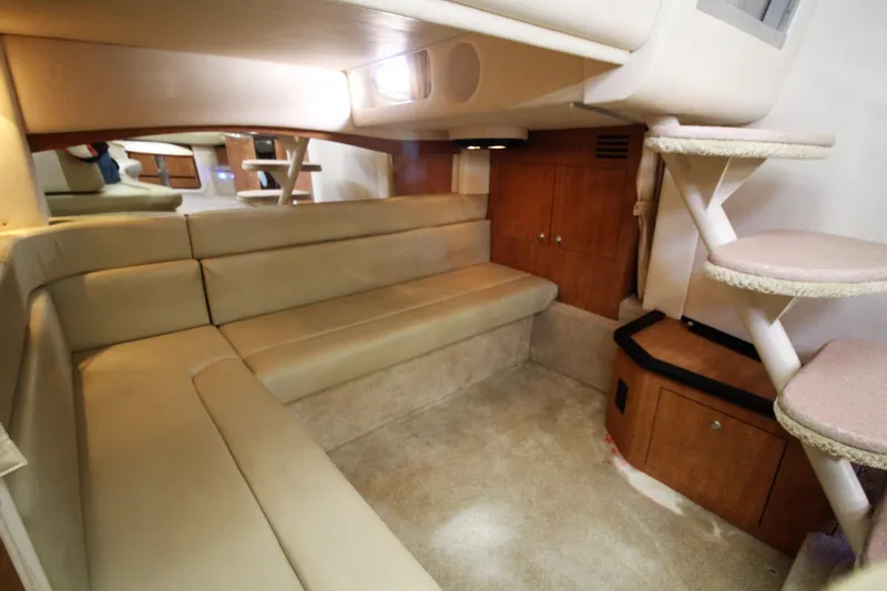  Yacht Photos Pics 2006 Sea Ray 340 Sundancer interior with beige seating and wooden cabinetry.