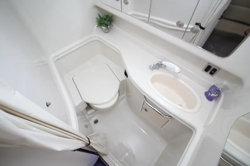  Yacht Photos Pics Bathroom interior of 2006 Sea Ray 340 Sundancer yacht, featuring toilet, sink, and mirror.