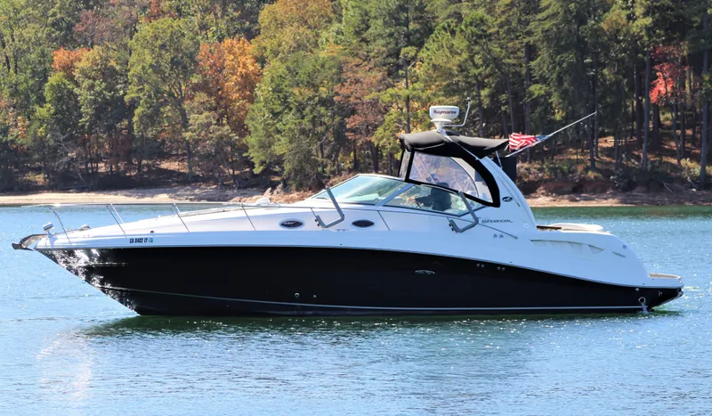  Yacht Photos Pics 2006 Sea Ray 340 Sundancer yacht on a serene lake with forested background.
