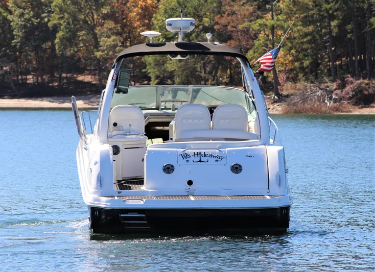  Yacht Photos Pics 2006 Sea Ray 340 Sundancer boat on a lake, rear view with American flag.