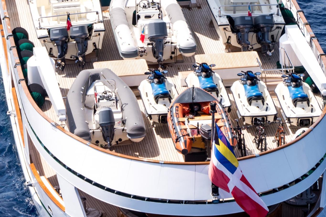 Deck of Codecasa ESMERALDA yacht with jet skis, boats, and flags, 1981 model.