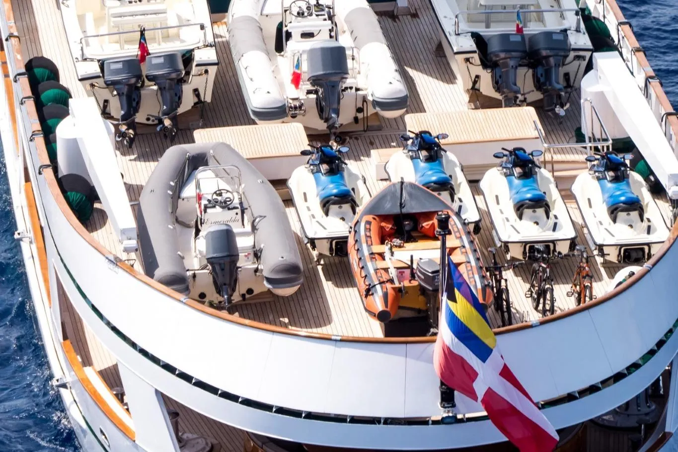 Deck of Codecasa ESMERALDA yacht with jet skis, boats, and flags, 1981 model.