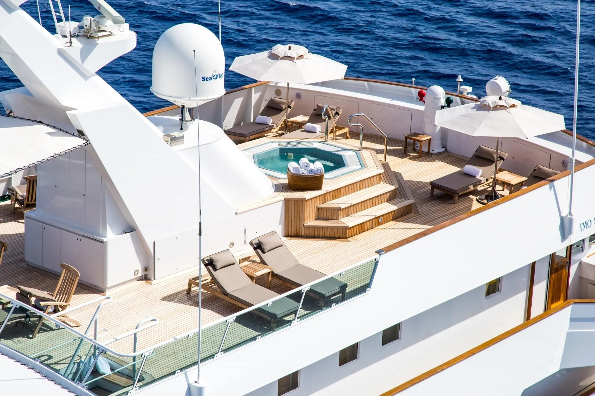 Luxurious deck of 1981 Codecasa ESMERALDA yacht with jacuzzi and sun loungers.