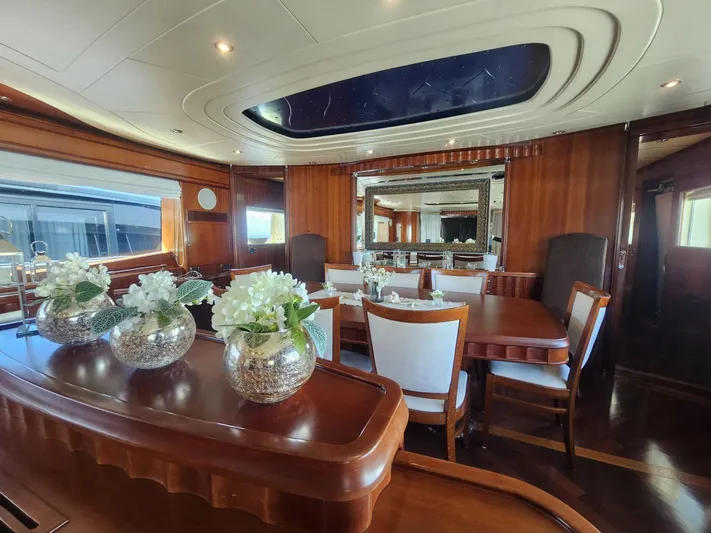 Naughty By Nature Yacht Photos Pics Luxurious interior of 2002 Rizzardi 105 yacht with elegant dining area and floral decor.