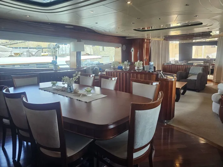 Naughty By Nature Yacht Photos Pics Luxurious interior of 2002 Rizzardi 105 yacht with elegant dining and seating areas.