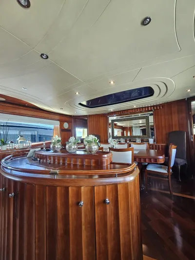 Naughty By Nature Yacht Photos Pics Luxurious interior of 2002 Rizzardi 105 yacht with elegant wood finishes and modern decor.