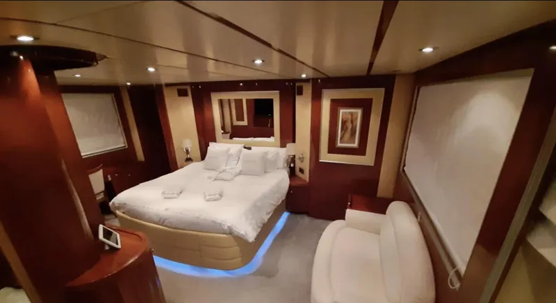 Naughty By Nature Yacht Photos Pics Luxurious bedroom interior of 2002 Rizzardi 105 yacht with elegant decor and ambient lighting.