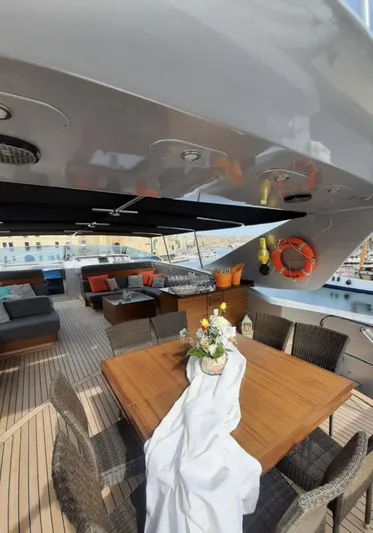 Naughty By Nature Yacht Photos Pics Luxurious 2002 Rizzardi 105 yacht deck with elegant dining area and stylish seating.