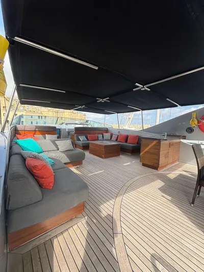 Naughty By Nature Yacht Photos Pics Luxurious 2002 Rizzardi 105 yacht deck with elegant seating and canopy.