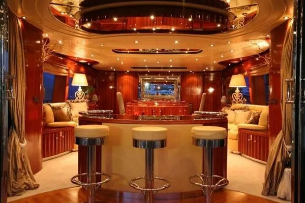 Naughty By Nature Yacht Photos Pics Luxurious interior of 2002 Rizzardi 105 yacht with elegant seating and ambient lighting.