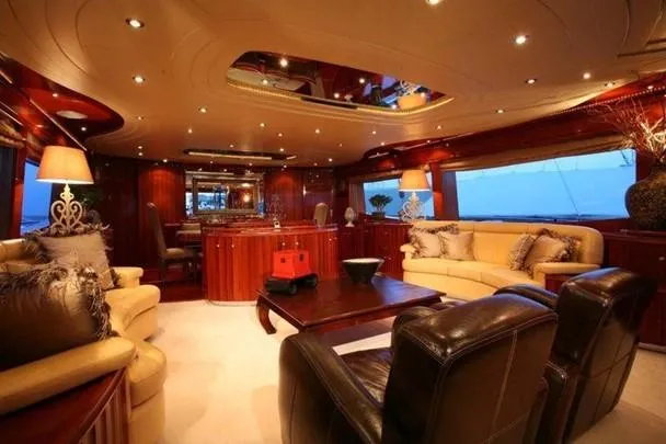Naughty By Nature Yacht Photos Pics Luxurious interior of 2002 Rizzardi 105 yacht with elegant seating and ambient lighting.