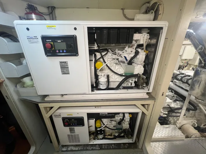 Lidia Yacht Photos Pics Engine room of 2006 Ferretti Yachts 830, featuring dual generators and control panels.