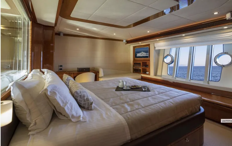 Lidia Yacht Photos Pics Luxurious bedroom interior of 2006 Ferretti Yachts 830 with ocean view and elegant decor.