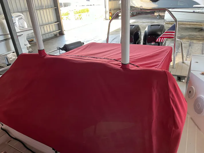  Yacht Photos Pics 2019 Axopar 37 Sun Top with red cover in a boat storage area.