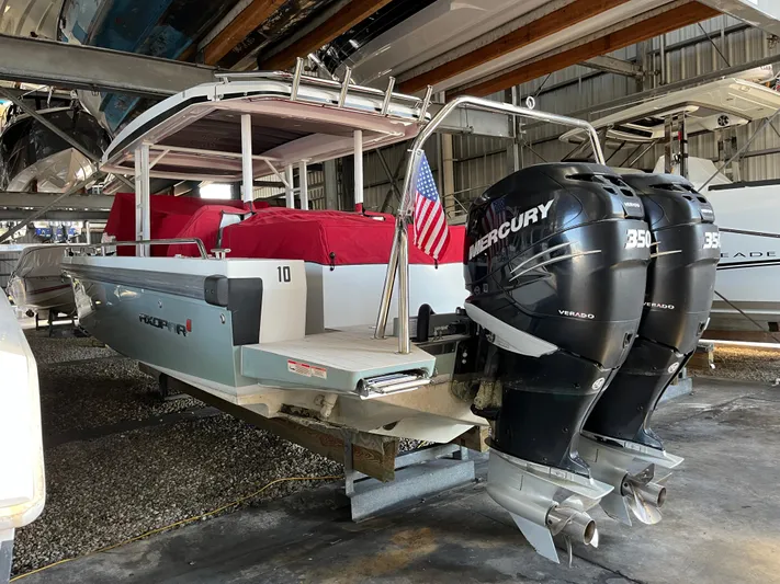  Yacht Photos Pics 2019 Axopar 37 Sun Top with twin Mercury 350 engines in a boat storage facility.