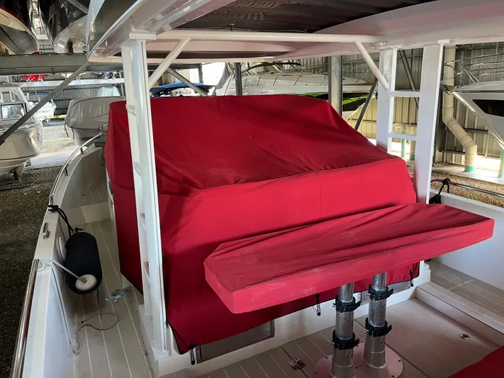  Yacht Photos Pics 2019 Axopar 37 Sun Top boat interior with red cover and seating.