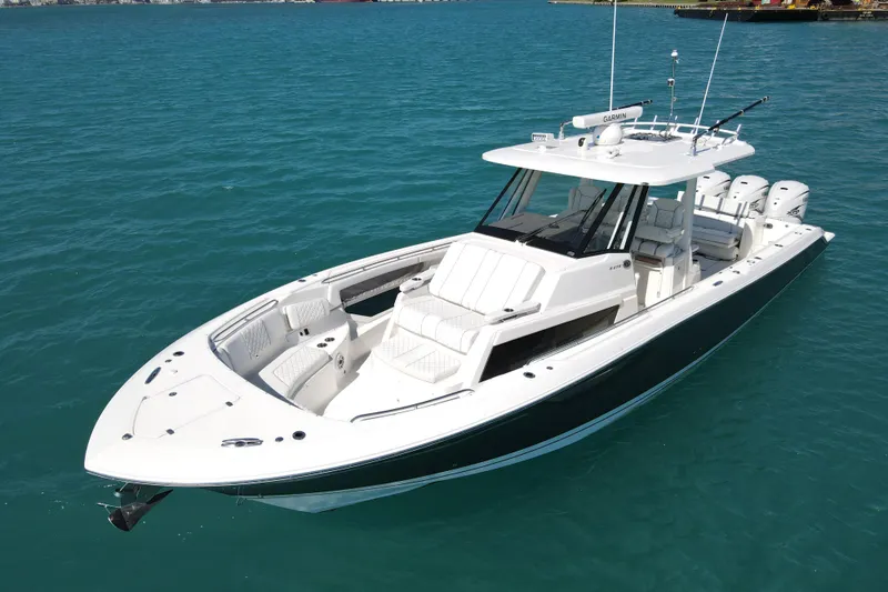  Yacht Photos Pics 2021 Pursuit S 378 Sport boat on clear blue water, showcasing sleek design and luxury features.