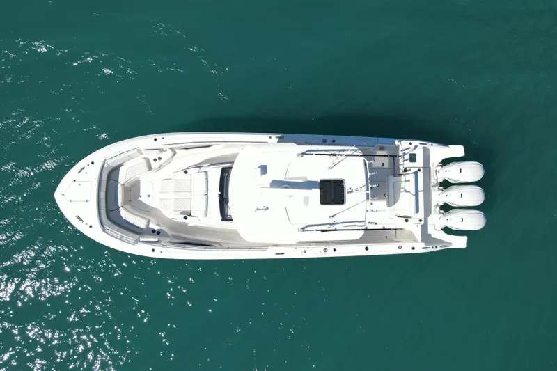  Yacht Photos Pics Aerial view of 2021 Pursuit S 378 Sport boat on clear blue water.