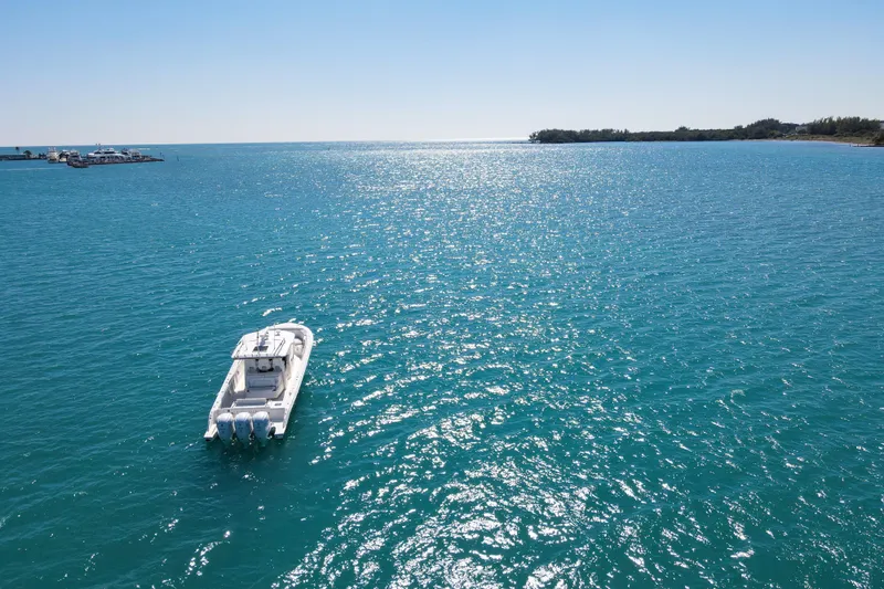  Yacht Photos Pics 2021 Pursuit S 378 Sport boat on sparkling blue ocean under clear sky.